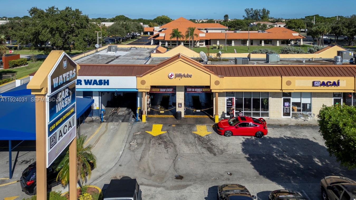 An aerial view shows a commercial strip center with a car wash and Jiffy Lube — 23133 Sandalfoot Plaza Dr, Boca Raton FL 33428, BOCA RATON, FL
