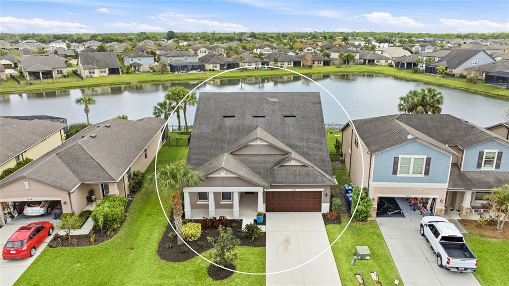 An aerial view shows a single-family house with a brown roof and a concrete driveway — 6224 KEVESTA AVENUE, PALMETTO, FL