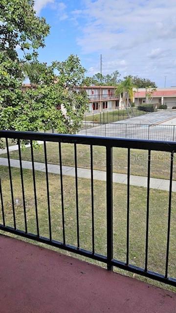 A view from a balcony overlooking a grassy courtyard and a multi-story apartment building — 43420 HIGHWAY 27 UNIT 242, DAVENPORT, FL