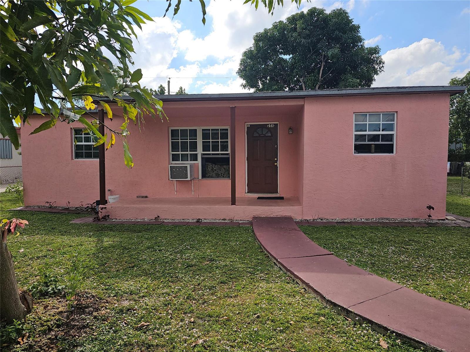 A single-story pink house with a brown front door and a concrete walkway — 2510 NW 6 Street, Pompano Beach FL 33069, POMPANO BEACH, FL