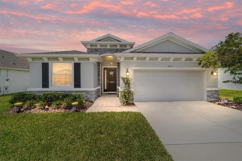 A single-story house with a stone-accented facade, a two-car garage, and a front walkway — 8611 SW 49TH CIRCLE, OCALA, FL