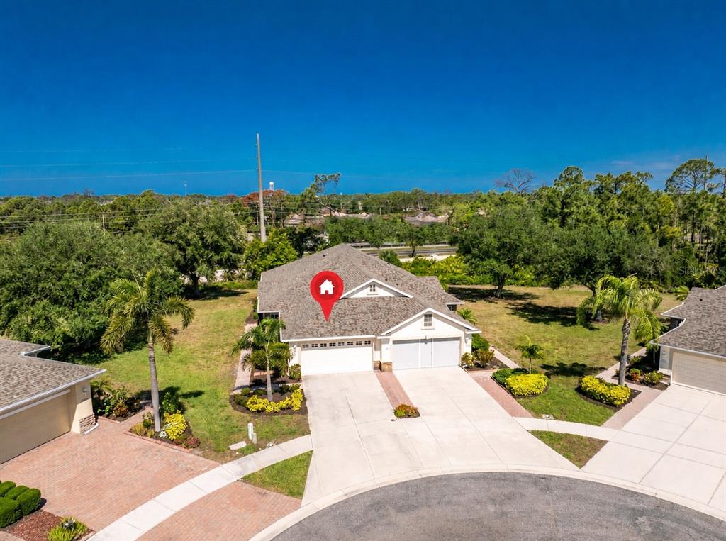 An aerial view shows a single-story house with a three-car garage and a paved driveway — 29633 NIAGARA COURT, ENGLEWOOD, FL