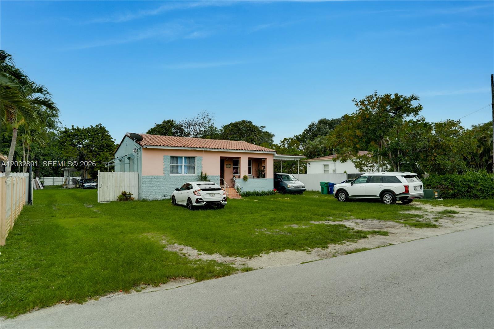 A single-story house with a peach and light blue exterior sits on a grassy lot — 5860 SW 19th St, Miami FL 33155, MIAMI, FL