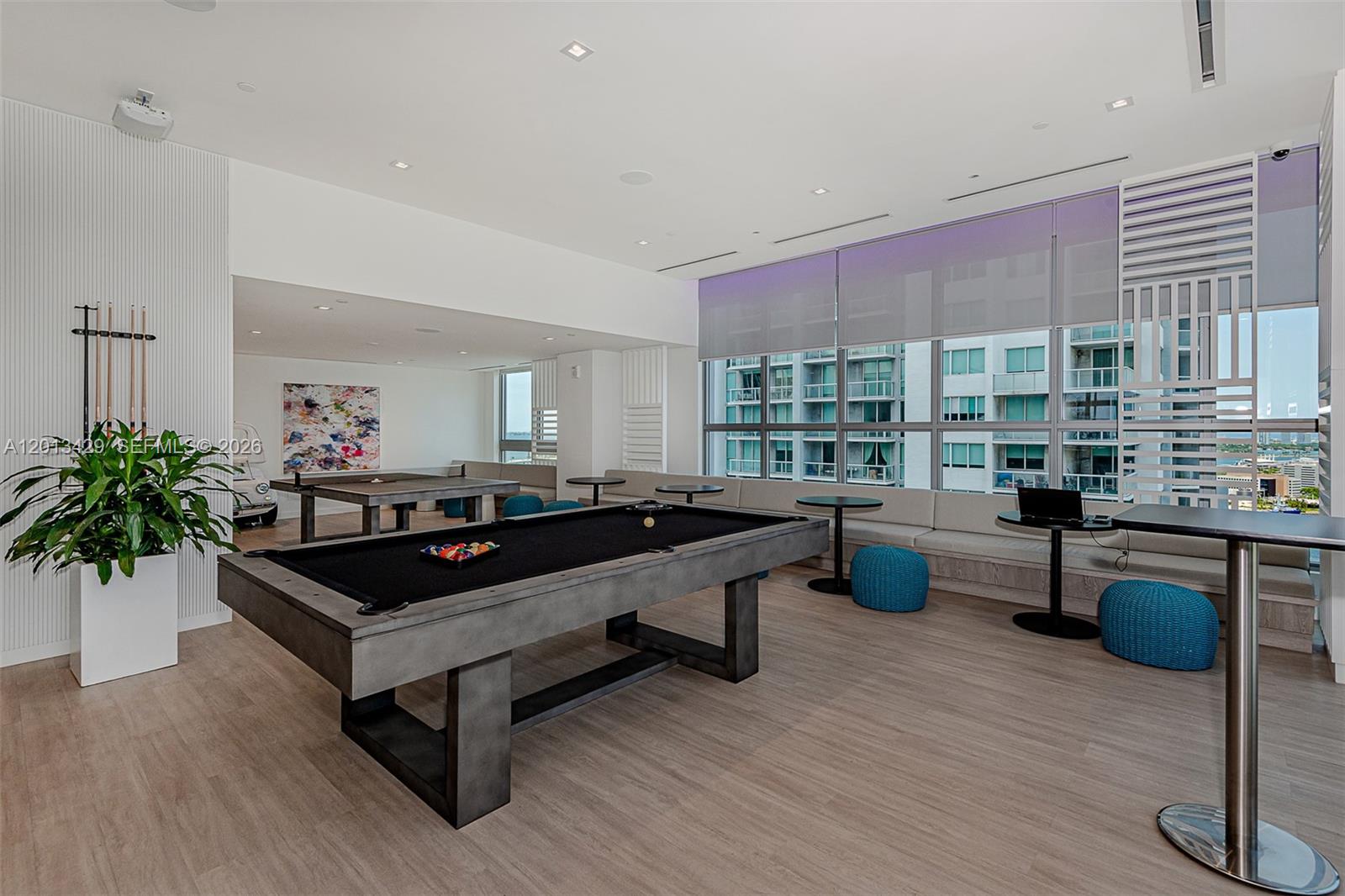 A modern game room features a pool table, ping pong table, and built-in bench seating — 227 NE 2nd St # 2206, Miami FL 33132, MIAMI, FL