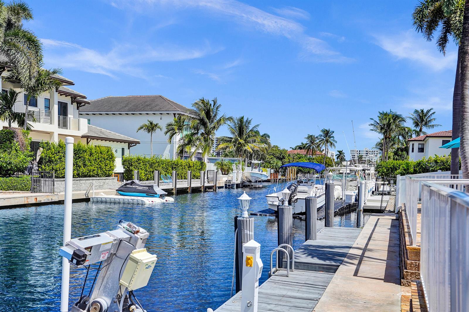 A canal view featuring a private boat dock, several docked boats, and surrounding residential homes — 785 NE 71st Street, Boca Raton FL 33487, BOCA RATON, FL