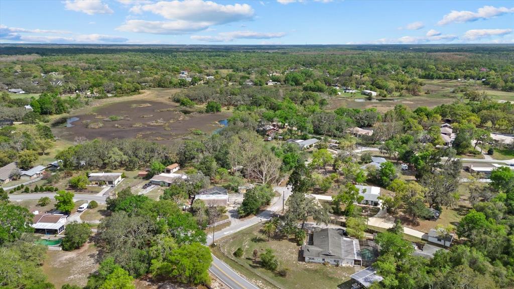 An aerial view shows houses scattered among trees and a large marshy area — INDALE DR, NEW PORT RICHEY, FL