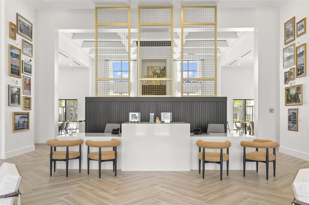 A reception desk with four chairs sits in a bright lobby with framed wall art — 7210 INTERBAY BOULEVARD UNIT B1, TAMPA, FL