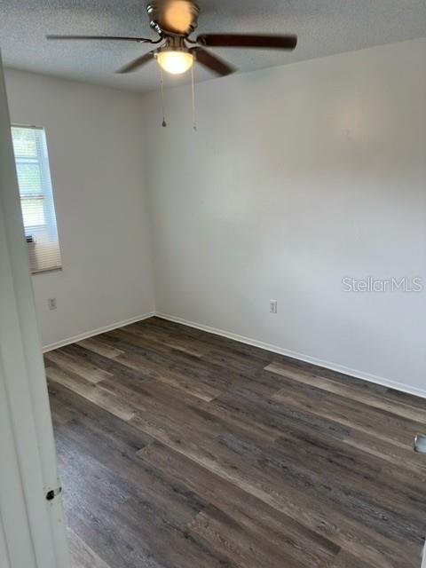 An empty bedroom features light-colored walls, a ceiling fan, and wood-look laminate flooring — 3648 MOUNT TABOR ROAD, LAKELAND, FL