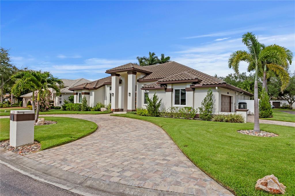 A single-story house with a tiled roof, stucco exterior, and a paved driveway — 1230 DARLINGTON OAK CIRCLE NE, ST PETERSBURG, FL
