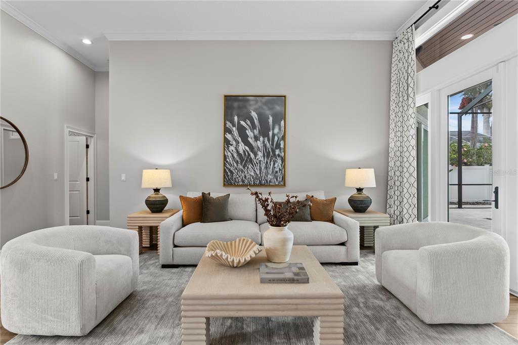 A living room features a light-colored sofa, two armchairs, a coffee table, and wall art — 1230 DARLINGTON OAK CIRCLE NE, ST PETERSBURG, FL