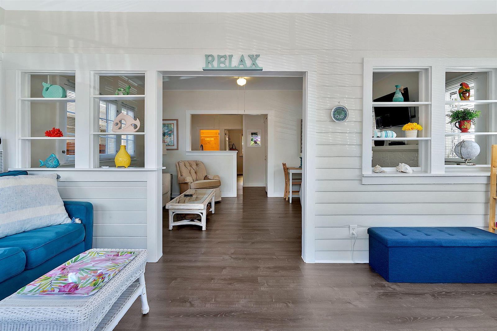 A living room features white shiplap walls, built-in shelving, and a blue sofa — 118 S J Street, FL 33460, FL