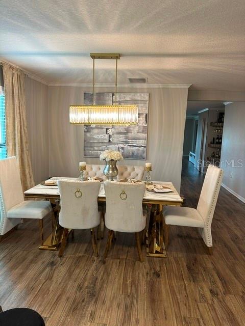 A dining room features a rectangular table, upholstered chairs, and a modern linear chandelier — 6900 CRESTED ORCHID DRIVE, BROOKSVILLE, FL