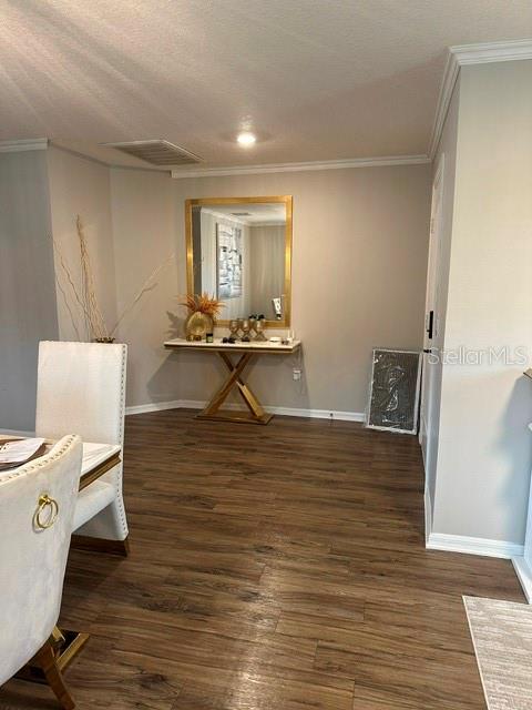 A dining area features wood-look flooring, a gold-framed mirror, and a console table — 6900 CRESTED ORCHID DRIVE, BROOKSVILLE, FL