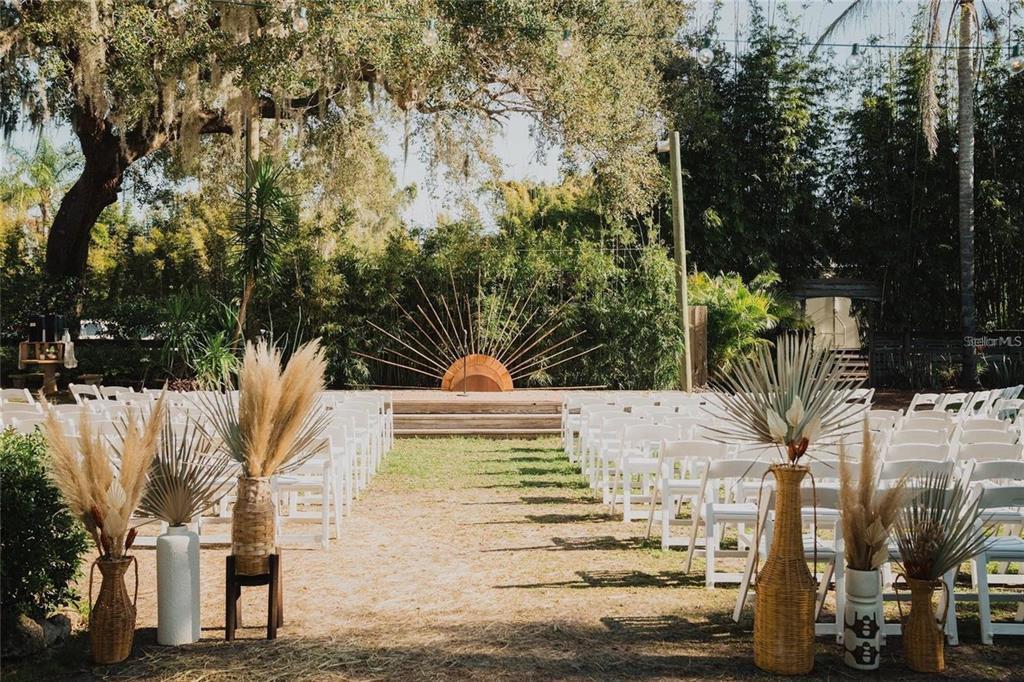 An outdoor wedding ceremony space features rows of white chairs facing a sunburst altar — 4421 EDGEWATER DRIVE, ORLANDO, FL