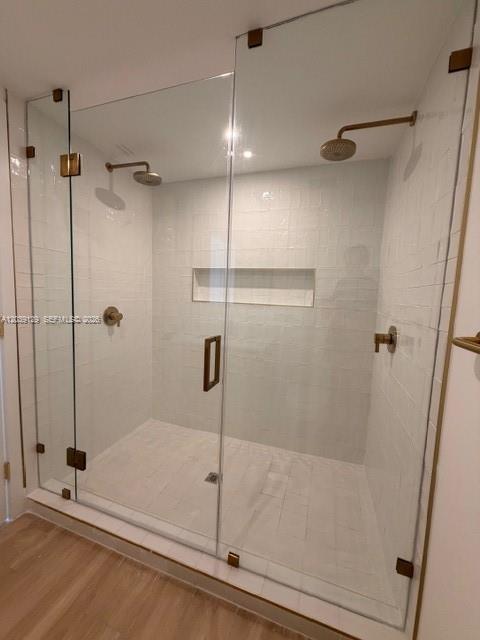 A walk-in shower features white subway tile, a recessed niche, and gold-toned hardware — 90 NE 32nd St # 823, Miami FL 33137, MIAMI, FL