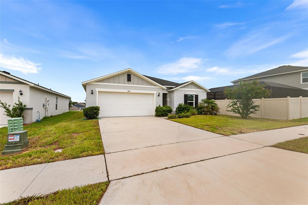A kitchen features white cabinets, granite countertops, stainless steel appliances, and a breakfast bar — 1425 ENGELBERG STREET, WINTER HAVEN, FL