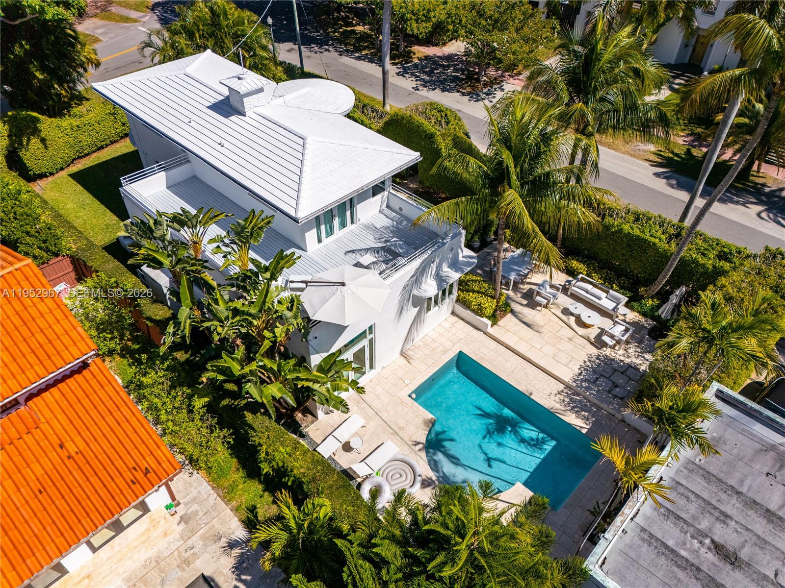 An aerial view shows a white house with a pool, patio, and surrounding palm trees — 4580 Post Ave, Miami Beach FL 33140, MIAMI BEACH, FL