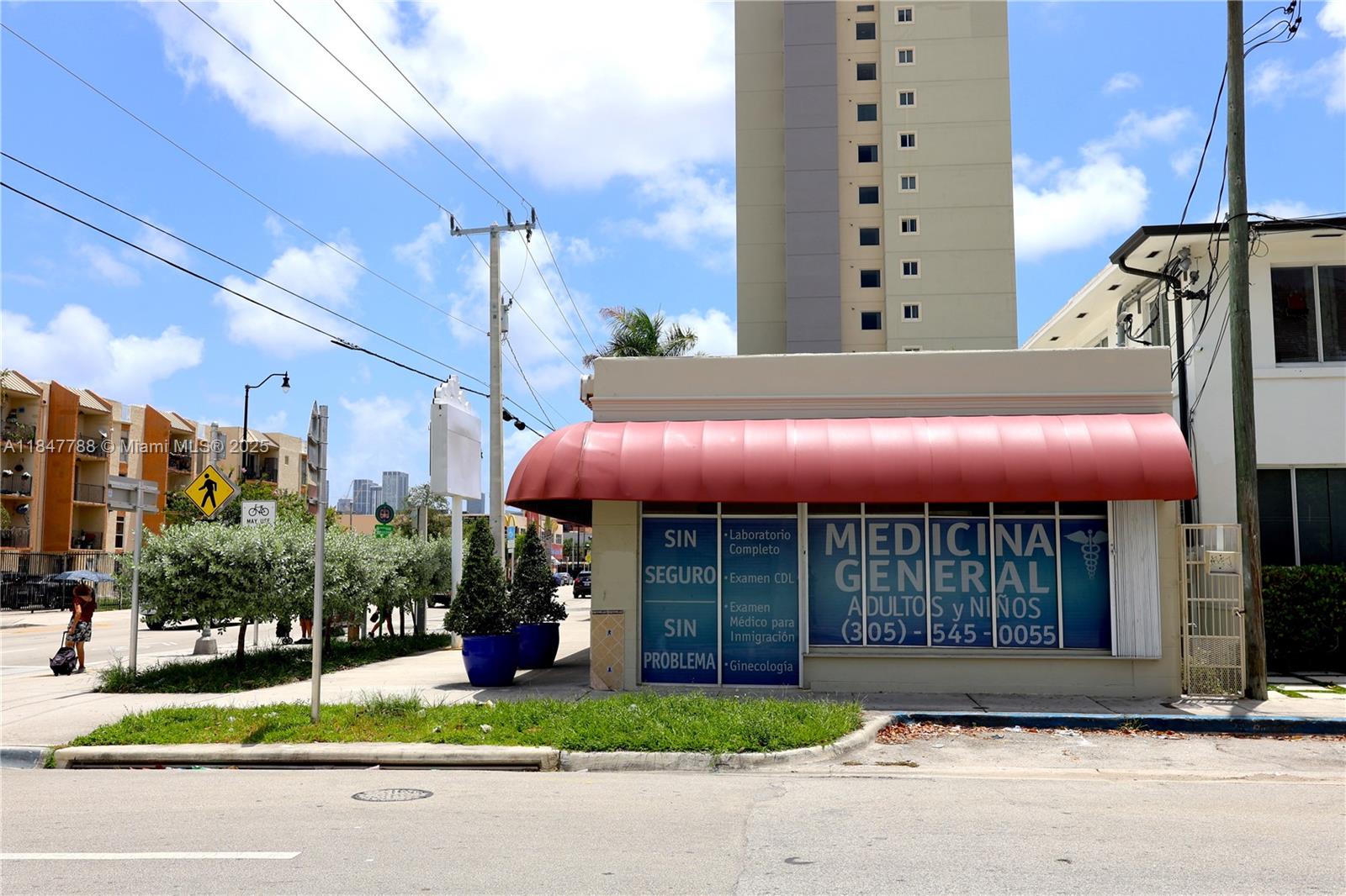 A small medical office building with a red awning sits on a corner lot — 1058 SW 1st St, Miami FL 33130, MIAMI, FL