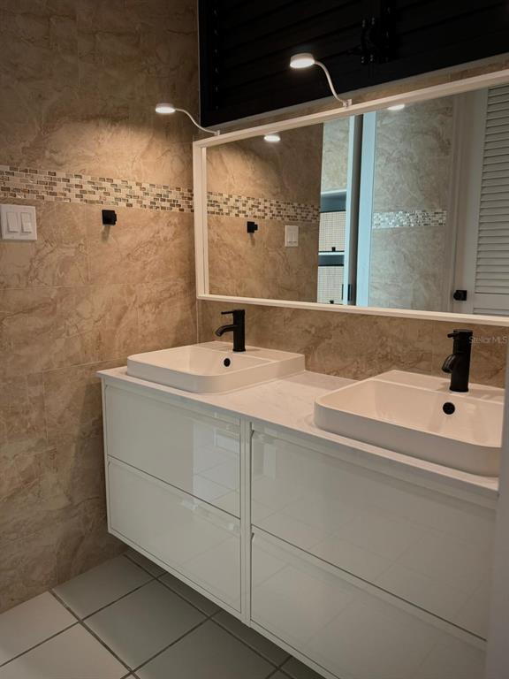 A bathroom features a double vanity with white cabinets, vessel sinks, and a large mirror — 702 PISOS DE MIRAMAR, SAN JUAN, PR