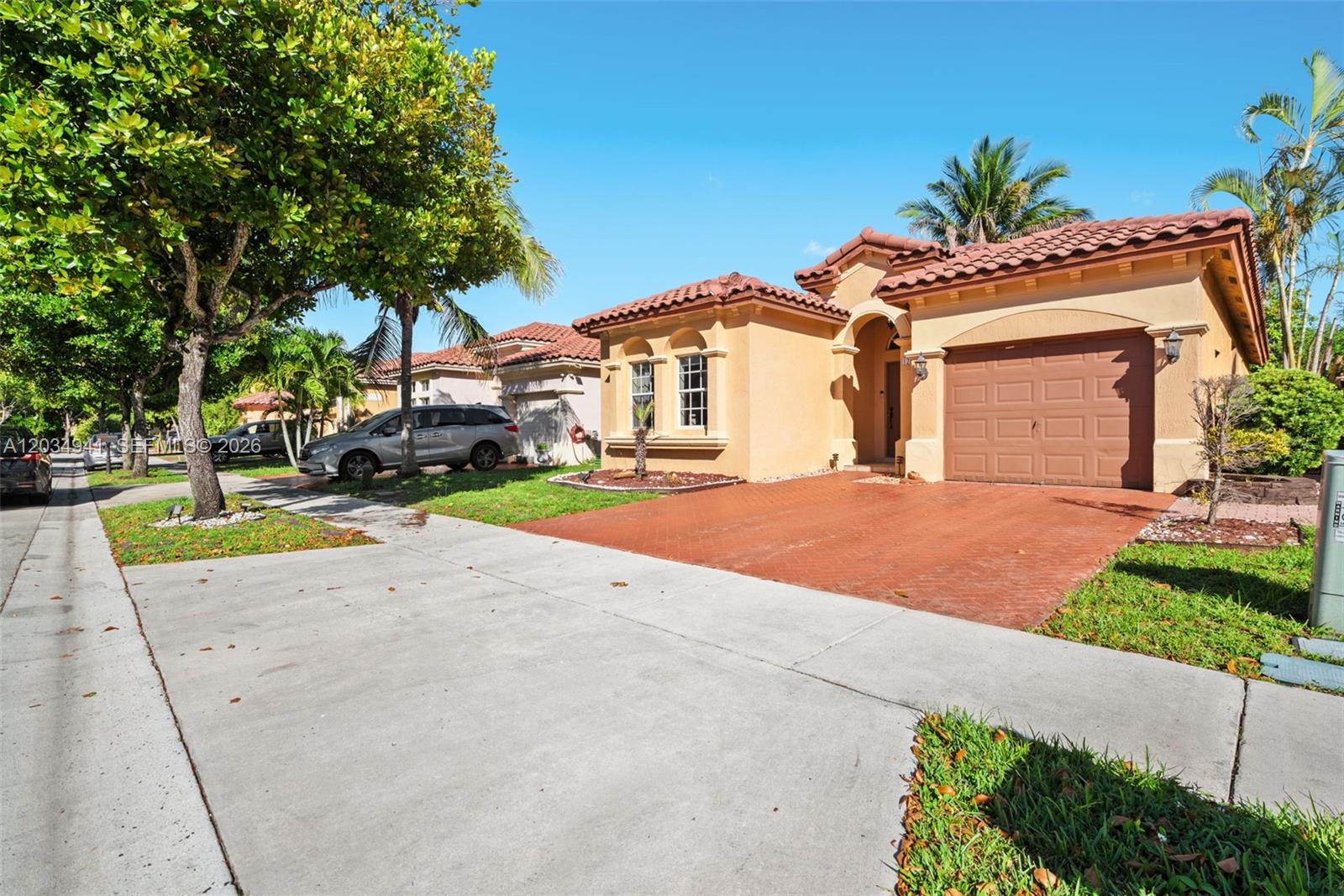 A single-story stucco house with a tile roof and a brick-paved driveway — 12870 SW 53rd St, Miramar FL 33027, MIRAMAR, FL