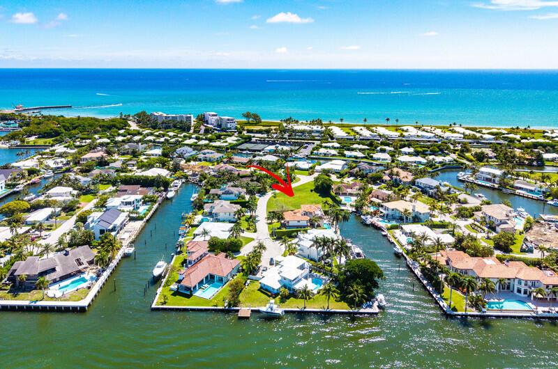 An aerial view shows a waterfront residential neighborhood with houses, swimming pools, and boat docks — 103 Bonito Drive, Ocean Ridge FL 33435, OCEAN RIDGE, FL
