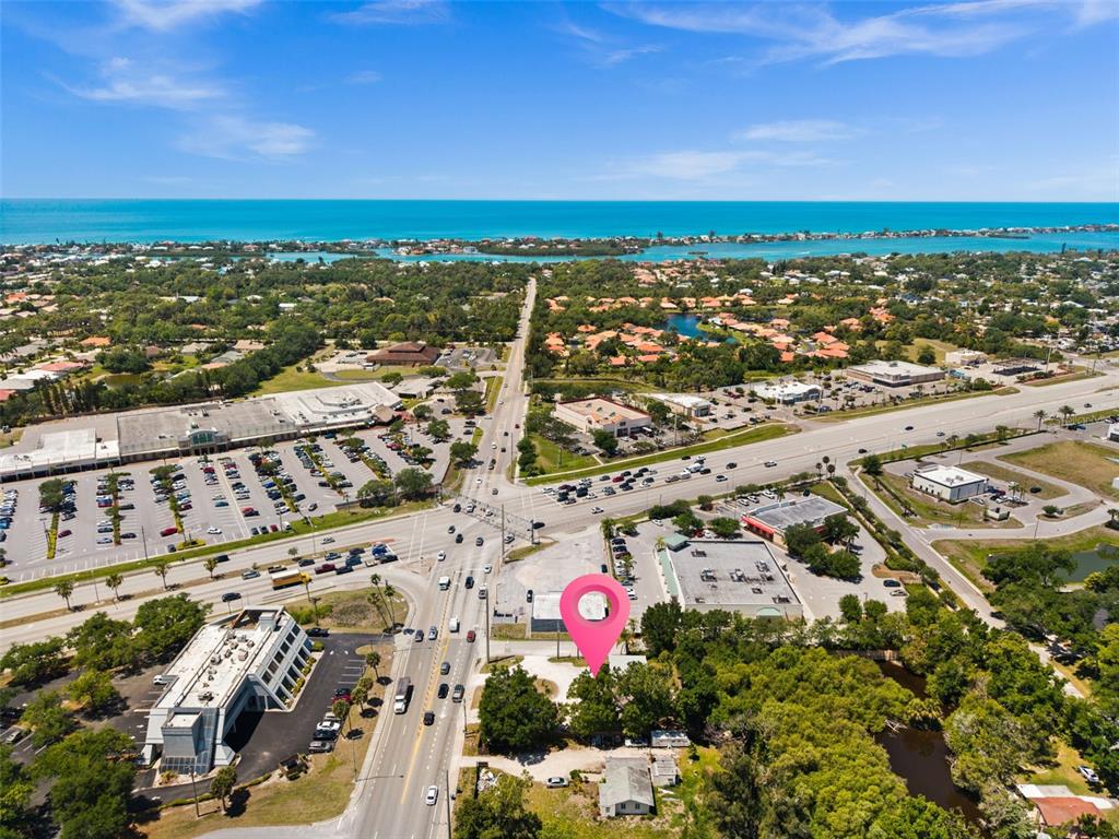 This aerial view shows a commercial property marked with a pin near a busy intersection — 109 LAUREL ROAD E, NOKOMIS, FL