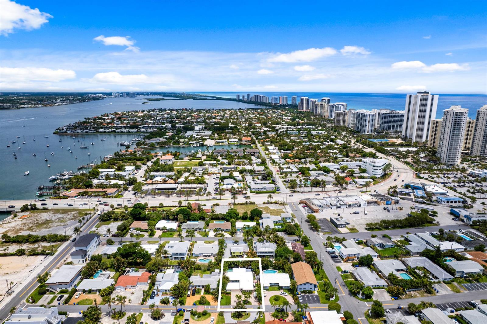 An aerial view shows a residential neighborhood with a highlighted single-story house near the coast — 1166 Beach Road, Singer Island FL 33404, SINGER ISLAND, FL
