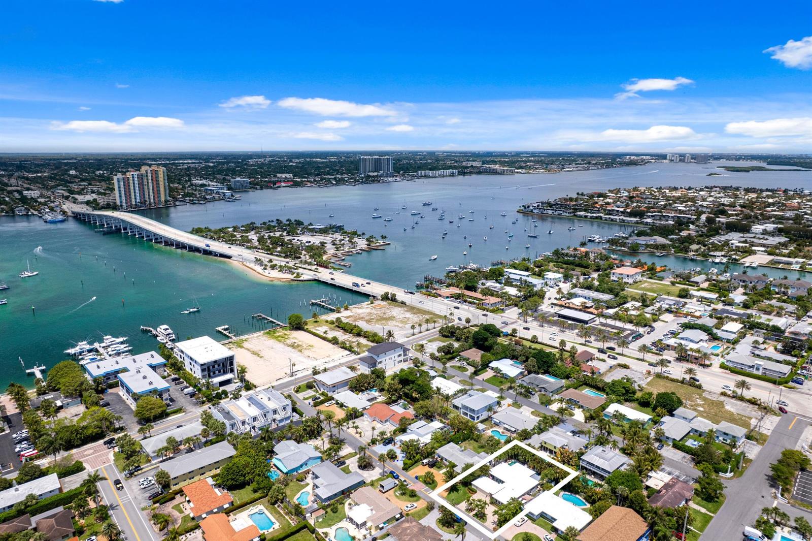 An aerial view shows a coastal neighborhood with a bridge, waterway, and highlighted house — 1166 Beach Road, Singer Island FL 33404, SINGER ISLAND, FL