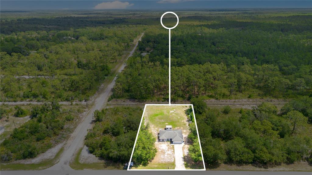 An aerial view shows a single-story house on a large, partially wooded lot — 3450 PARK AVENUE, INDIAN LAKE ESTATES, FL