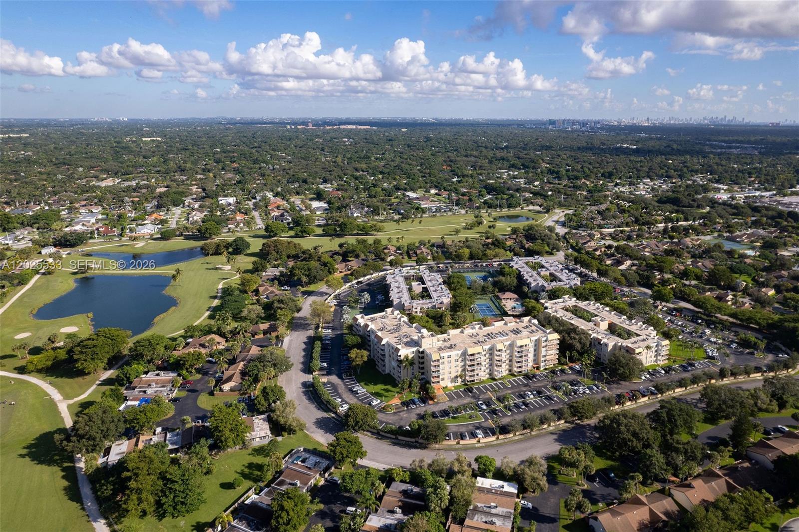 An aerial view shows a multi-story apartment complex surrounded by a golf course and trees — 13120 SW 92nd Ave # B505, Miami FL 33176, MIAMI, FL
