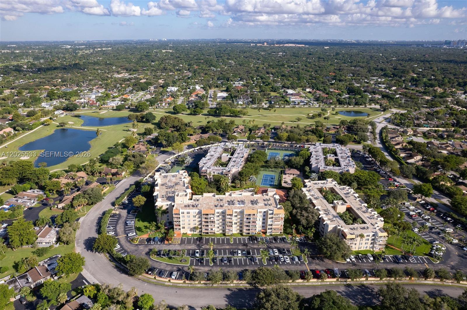 An aerial view shows a multi-story apartment complex with tennis courts and surrounding parking lots — 13120 SW 92nd Ave # B505, Miami FL 33176, MIAMI, FL