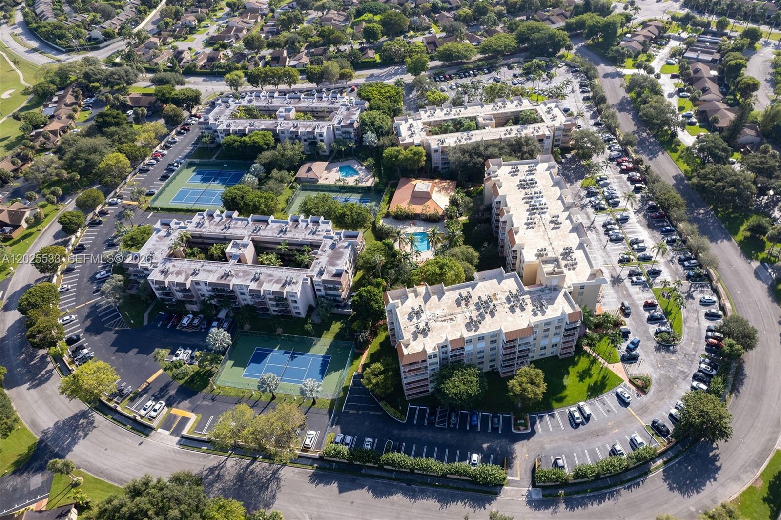 An aerial view shows a residential complex with apartment buildings, swimming pools, and tennis courts — 13120 SW 92nd Ave # B505, Miami FL 33176, MIAMI, FL