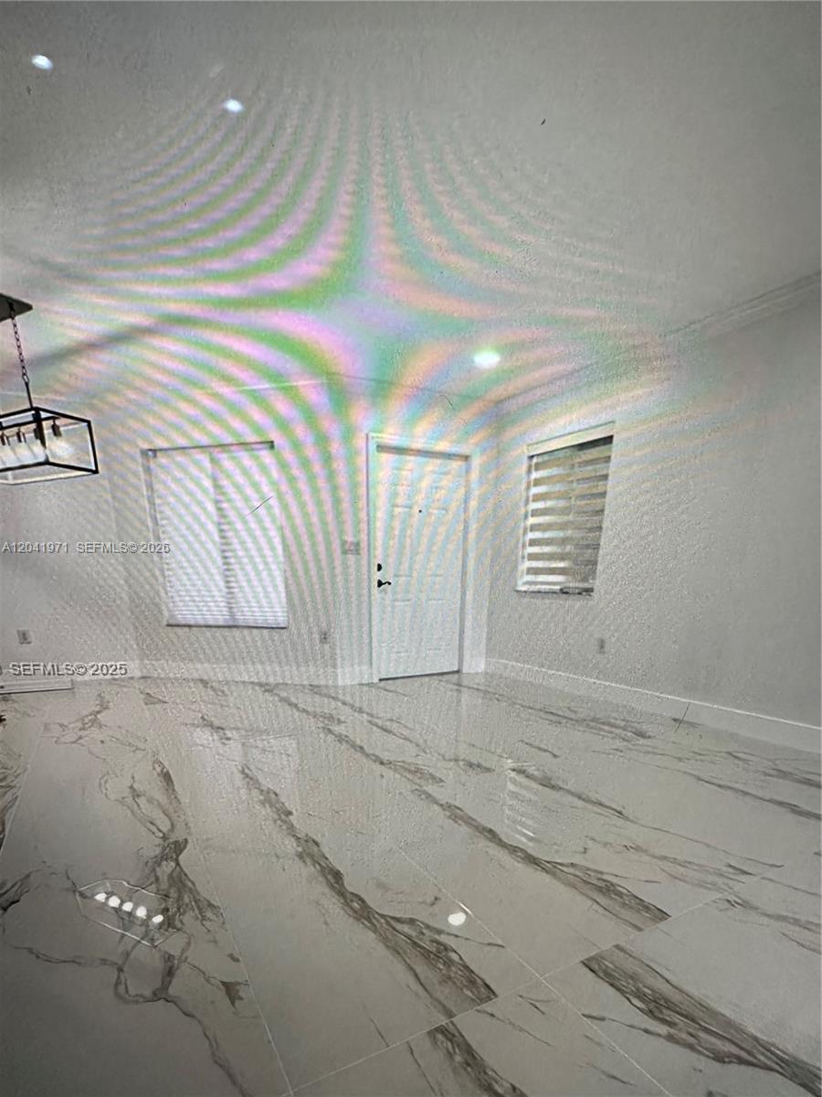 A room with white walls, a white door, and polished white marble-patterned tile flooring — 7001 SW 164th Ct # 0, Miami FL 33193, MIAMI, FL