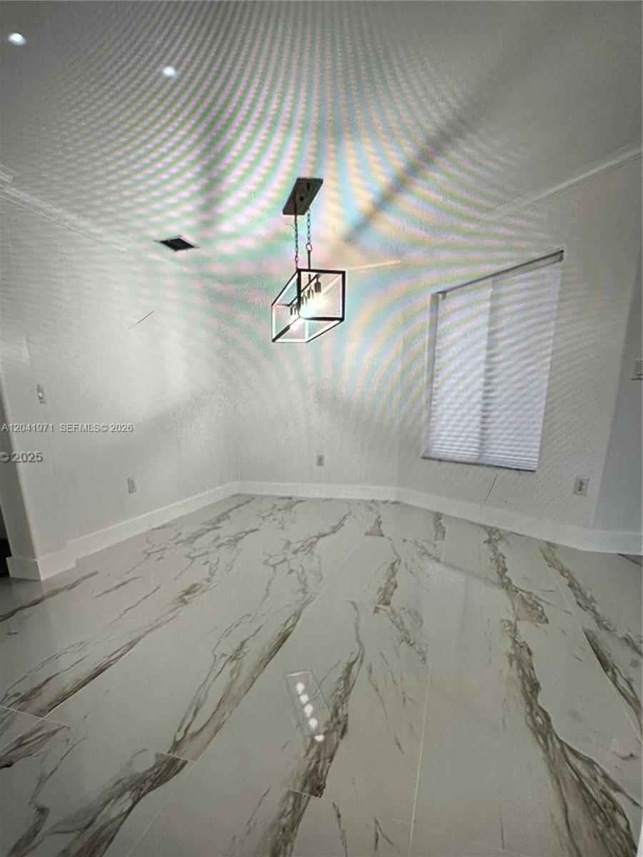 A dining area features white marble-patterned tile flooring and a modern black geometric pendant light — 7001 SW 164th Ct # 0, Miami FL 33193, MIAMI, FL