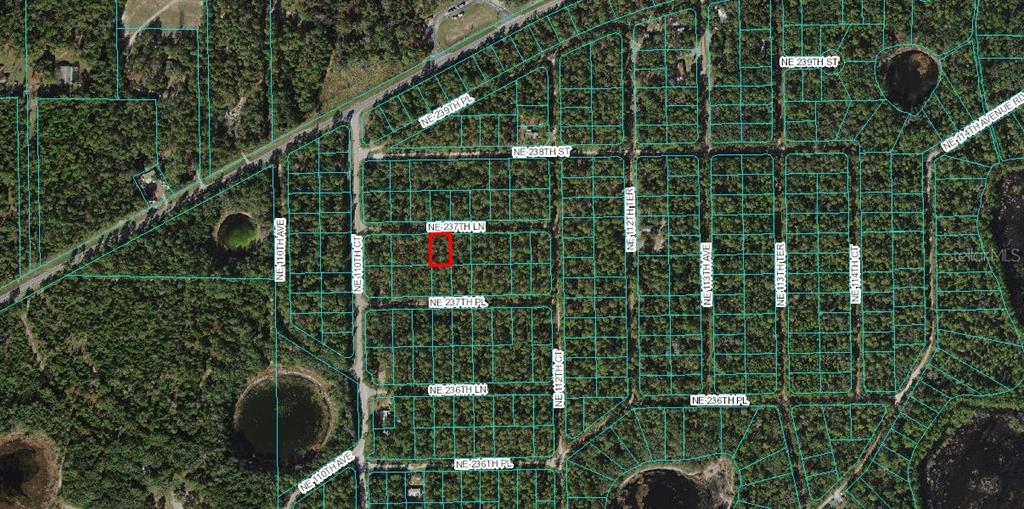 This is an aerial map showing a highlighted rectangular land parcel within a wooded subdivision — LOT 4 NE 237TH LANE, FORT MC COY, FL