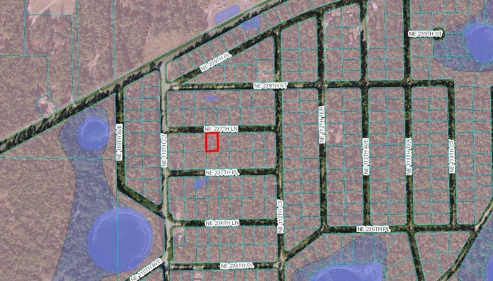 This is an aerial map showing a highlighted rectangular property lot within a residential neighborhood — LOT 4 NE 237TH LANE, FORT MC COY, FL