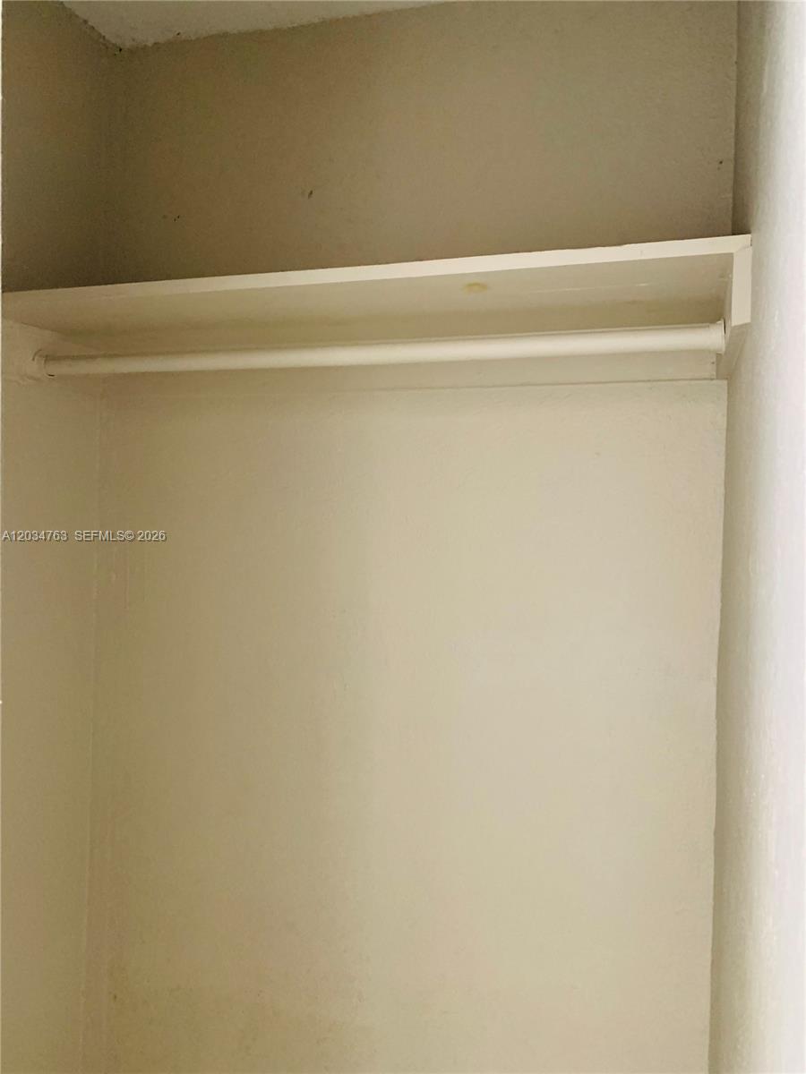 This is a small, empty closet featuring a single white shelf and a hanging rod — 1265 SW 6th St # 13, Miami FL 33135, MIAMI, FL