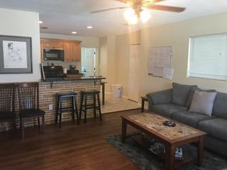 A living room with a gray sofa, coffee table, and a kitchen bar area — 817 S B Street, FL 33460, FL