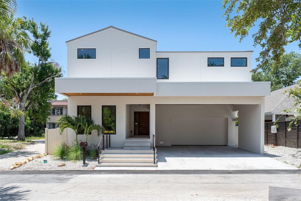 A low-angle view shows a wooden ceiling soffit with recessed lighting under a modern overhang — 1680 CHERRY LANE, SARASOTA, FL