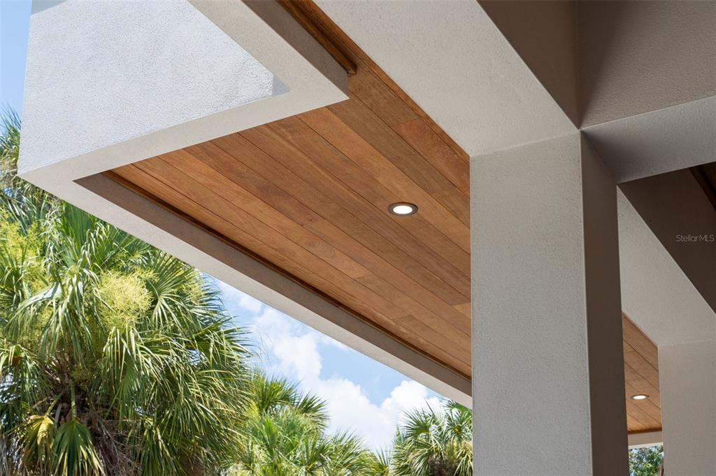 The exterior of a modern white house features a concrete staircase with metal railings — 1680 CHERRY LANE, SARASOTA, FL