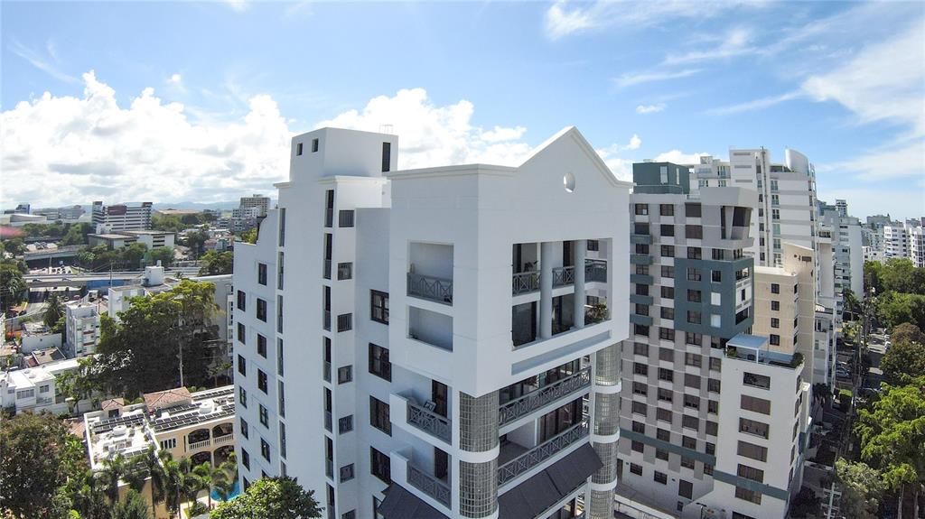 An aerial view of a white multi-story apartment building with balconies and glass block accents — 1360 LUCHETTI STREET, CROWNE PLAZA UNIT PH, SAN JUAN, PR