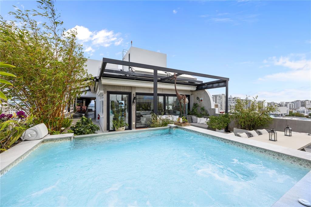 A rooftop terrace features a swimming pool, a pergola, and potted bamboo plants — 1360 LUCHETTI STREET, CROWNE PLAZA UNIT PH, SAN JUAN, PR