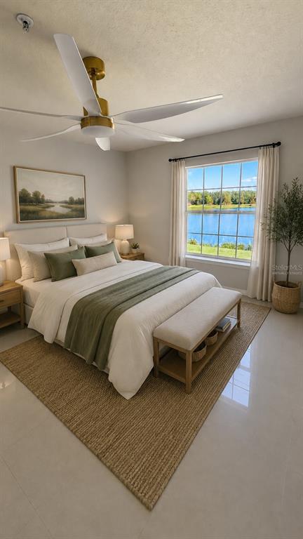 This bedroom features a bed with green accents, a ceiling fan, and a lake view — 4209 WOODSTORKS WALK WAY UNIT 209, LUTZ, FL