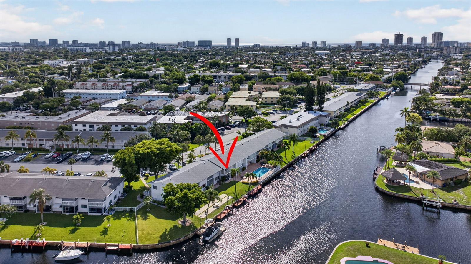An aerial view of a waterfront apartment building with a pool and boat docks — 800 Pine Drive # 13, Pompano Beach FL 33060, POMPANO BEACH, FL