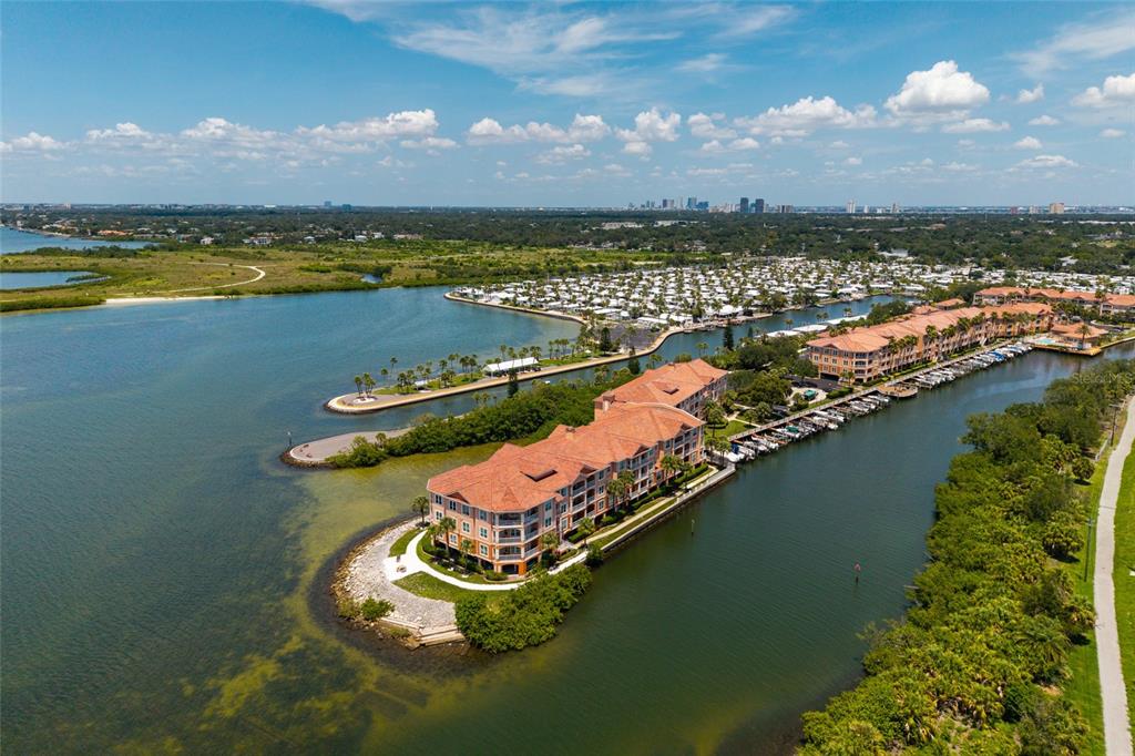 An aerial view shows a waterfront condominium complex with boat slips and a nearby marina — 5000 CULBREATH KEY WAY UNIT 4-105, TAMPA, FL