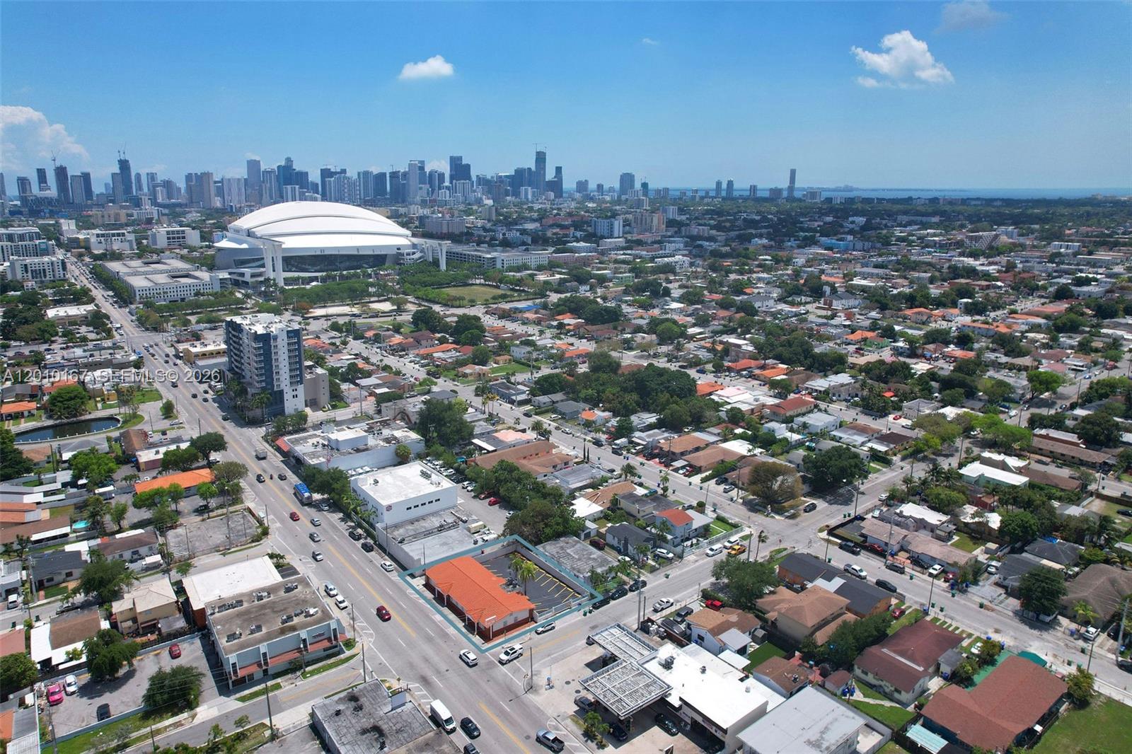 An aerial view shows a commercial building with a parking lot in a residential neighborhood — 1888 NW 7th St, Miami FL 33125, MIAMI, FL