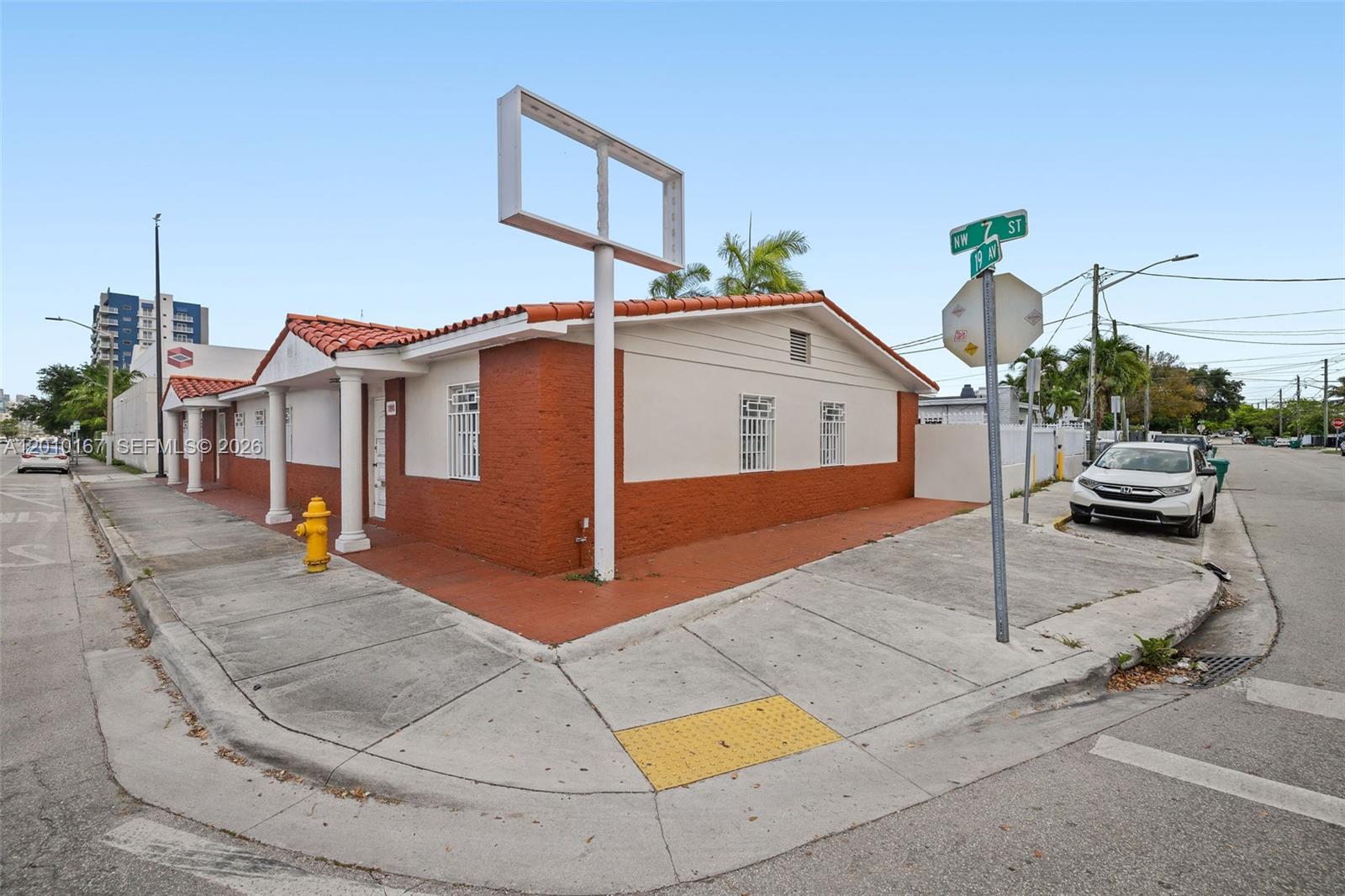 A one-story building with a red and white exterior sits on a street corner — 1888 NW 7th St, Miami FL 33125, MIAMI, FL