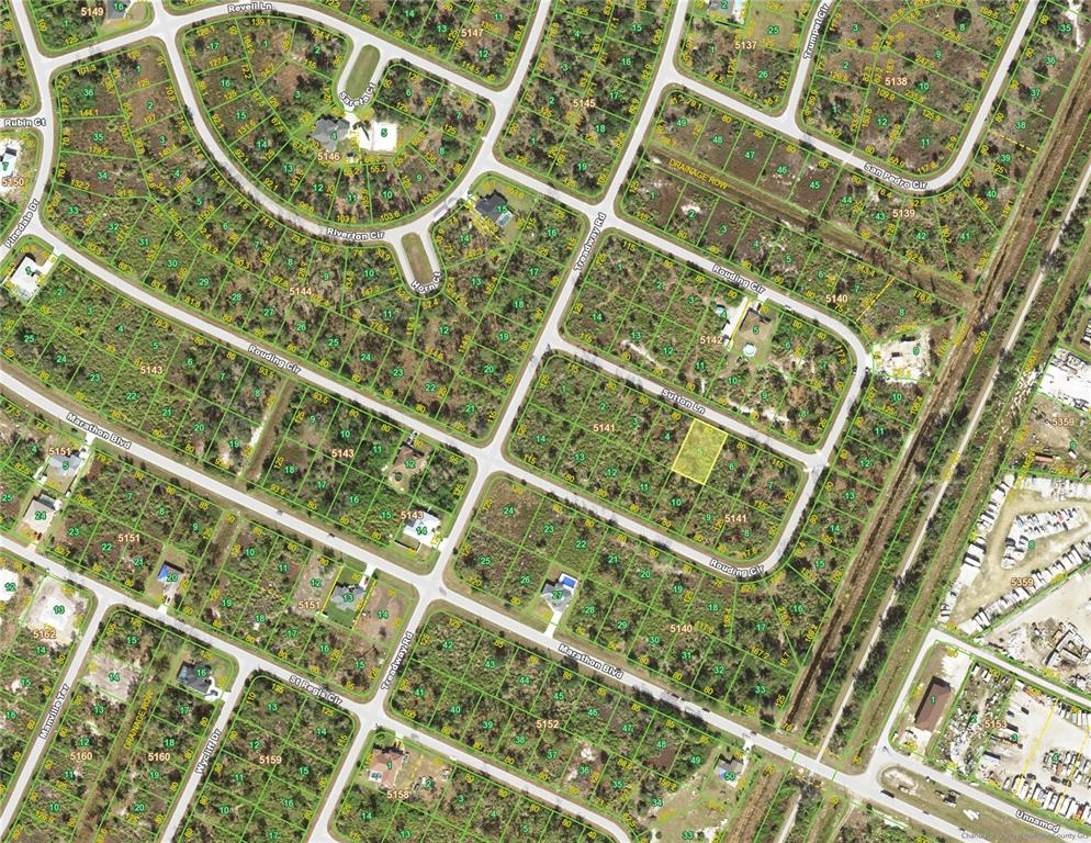 This is an aerial map showing residential lots and streets in a suburban neighborhood — 7365 SUTTON LANE, PORT CHARLOTTE, FL