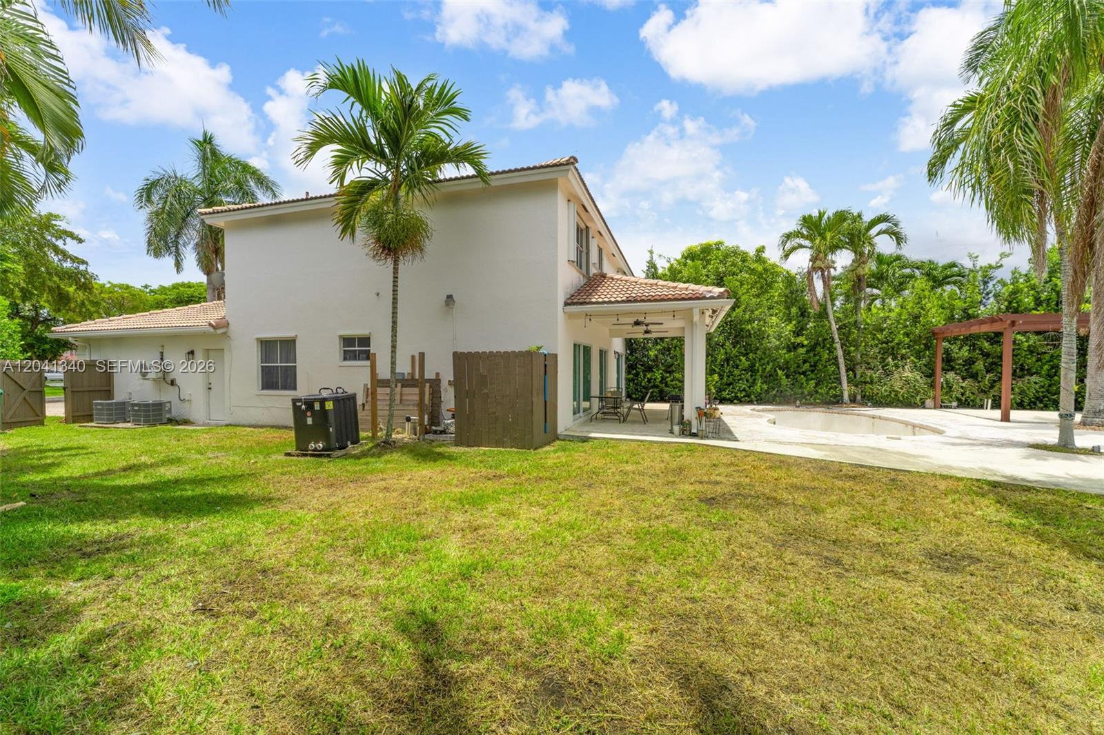 The exterior of a two-story house features a backyard with a pool and patio — 16335 SW 81 St, Miami FL 33193, MIAMI, FL