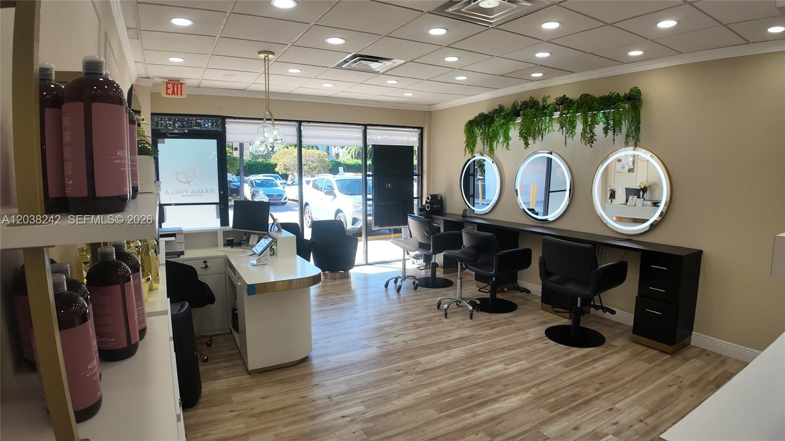 A modern hair salon features three circular lighted mirrors, black styling chairs, and wood-look flooring — 4721 NW 79th Ave, Doral FL 33166, DORAL, FL